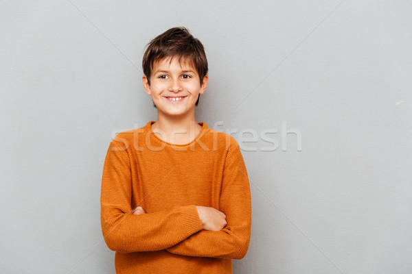 Boldog kicsi fiú áll keresztbe tett kar arc Stock fotó © deandrobot