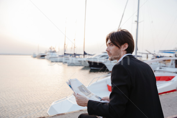 Side portrait of man in suit with newspaper Stock photo © deandrobot