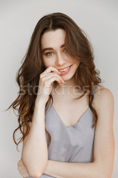 Vertical image of smiling woman in nightie Stock photo © deandrobot