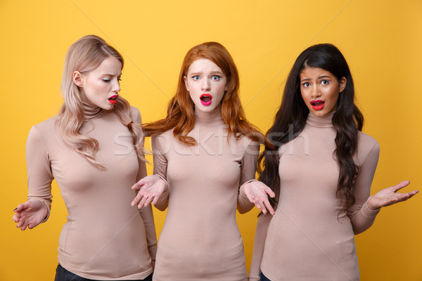 Confused three ladies standing with the tied hair. Stock photo © deandrobot