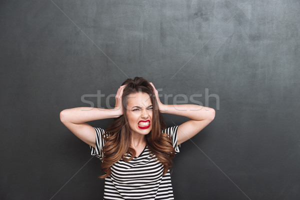 Young Screaming woman covering her ears Stock photo © deandrobot