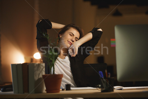 Bored young woman designer sitting in office at night Stock photo © deandrobot