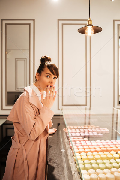 Girl looking at pastries through glass showcase at the cafe Stock photo © deandrobot