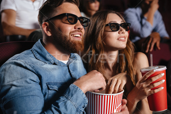 Concentrated loving couple friends sitting in cinema Stock photo © deandrobot