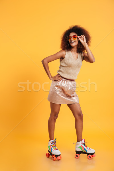 Full length portrait of a smiling afro american woman Stock photo © deandrobot