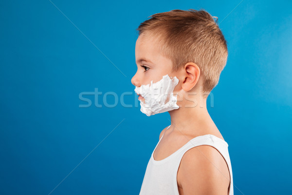 Profile of young serious boy in shaving foam like man Stock photo © deandrobot