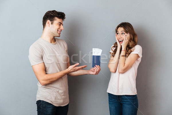 Stock photo: Portrait of a smiling man giving to his girlfriend passport