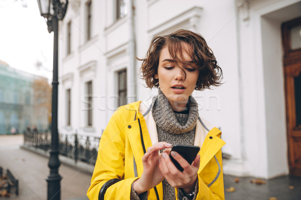 Incroyable jeune femme imperméable photo marche extérieur [[stock_photo]] © deandrobot