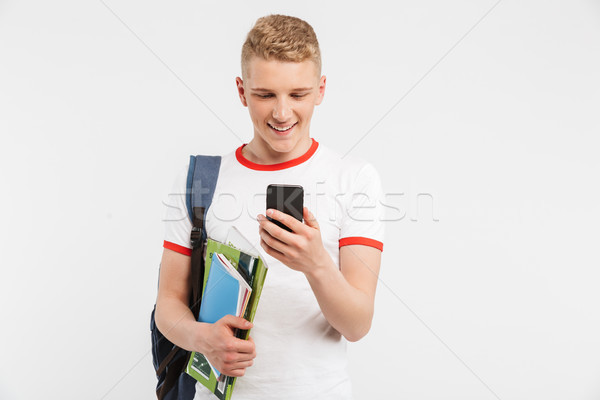 Portrait of teenage student boy wearing backpack smiling and loo Stock photo © deandrobot