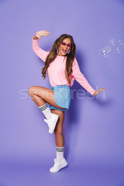 Full length portrait of european teenage girl with two ponytails Stock photo © deandrobot