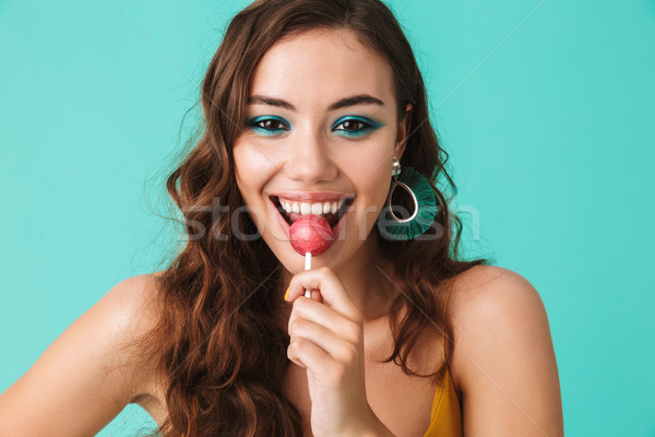 Portrait of beautiful happy woman 20s with playful look smiling  Stock photo © deandrobot