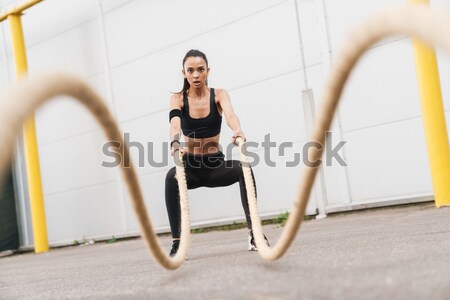 Woman reading for training with kettle ball Stock photo © deandrobot