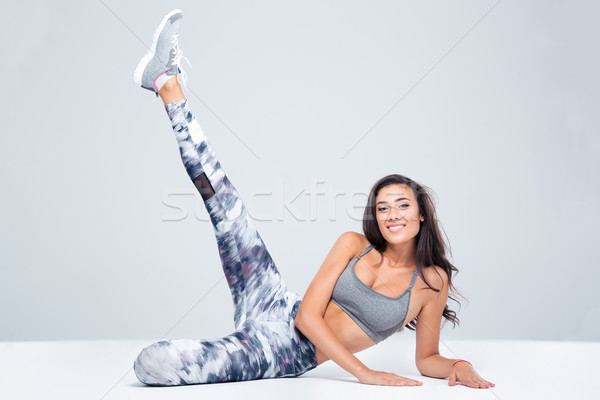 Sports woman stretching legs on the floor Stock photo © deandrobot