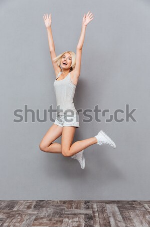 Charming young girl doing acrobatic stunt  Stock photo © deandrobot
