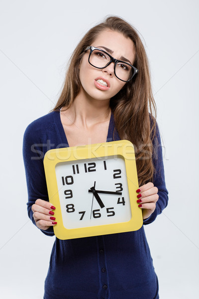 Portrait of a sad woman holding wall clock  Stock photo © deandrobot