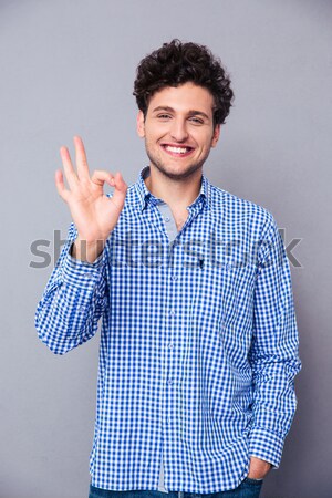 Afro american man holding something invisible Stock photo © deandrobot