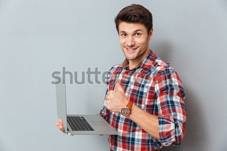 Jóképű fiatalember kockás póló laptopot használ szürke Stock fotó © deandrobot