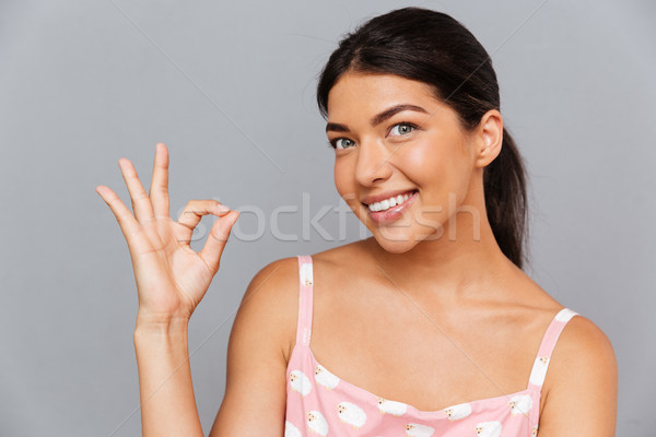 Smiling woman showing ok sign Stock photo © deandrobot