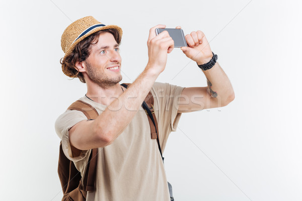 Happy young man with backpack making selfie Stock photo © deandrobot