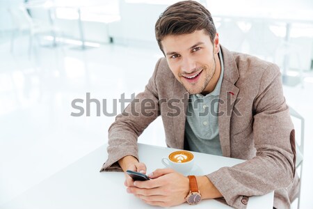 Sonriendo jóvenes empresario escribiendo mensaje Foto stock © deandrobot