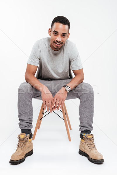 Smiling young dark skinned man Stock photo © deandrobot