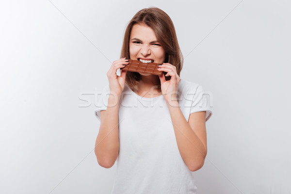 飢えた 若い女性 食べ チョコレート 画像 見える ストックフォト © deandrobot