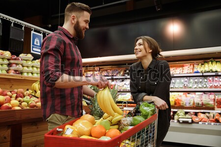 Heureux jeunes affectueux couple supermarché [[stock_photo]] © deandrobot
