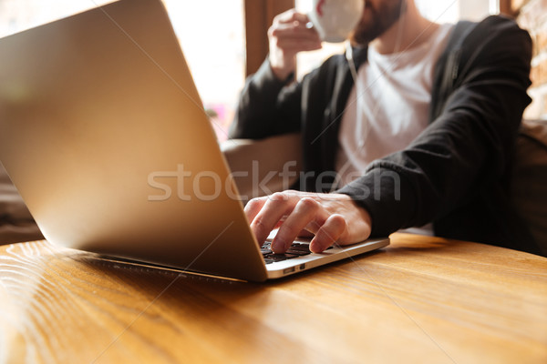 Cropped image of man in cafe near the window Stock photo © deandrobot