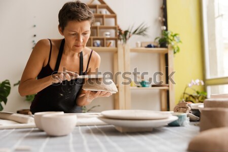 Stock photo: Pretty dreaming girl sitting at the cafe table