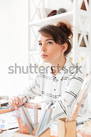Concentrated thinking woman fashion illustrator Stock photo © deandrobot