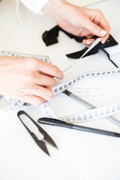 Close up of seamstress working with measuring tape Stock photo © deandrobot