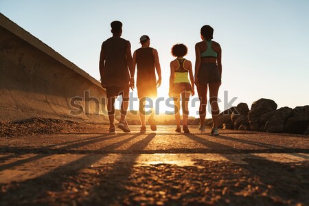 Full length image of fitness people walking outdoors Stock photo © deandrobot