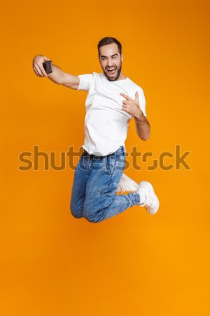 Emotional retro woman dressed in shirt holding boombox. Stock photo © deandrobot