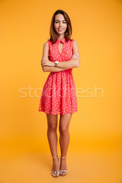 Full length pfoto of beautiful smiling woman standing with cross Stock photo © deandrobot