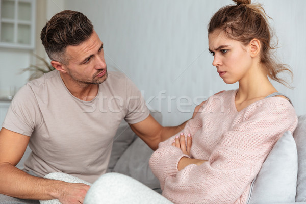 Side view of man sitting on couch and calm down Stock photo © deandrobot