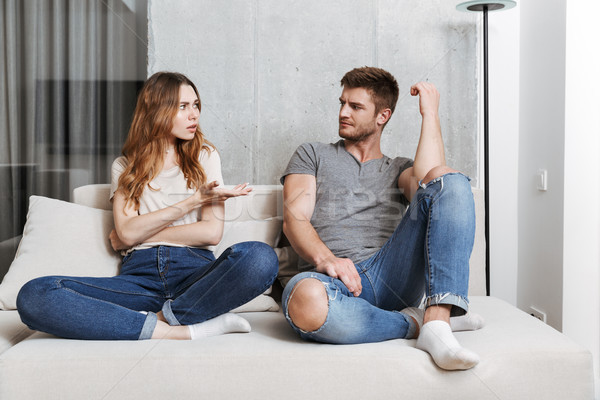 Offended displeased young loving couple Stock photo © deandrobot