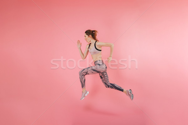Serious concentrated young fitness sports woman Stock photo © deandrobot