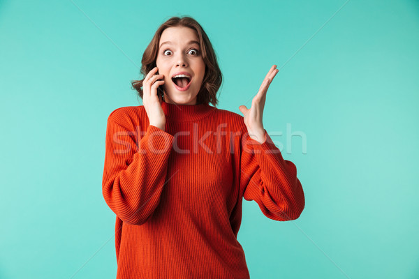 ストックフォト: 肖像 · 興奮した · 若い女性 · セーター · 話し · 携帯電話