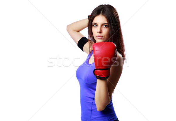 Young confident sport woman standing with boxing gloves isolated on gray background Stock photo © deandrobot