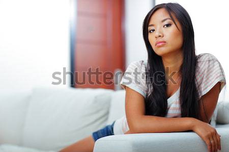 Attractive young woman reading the newspaper at office Stock photo © deandrobot