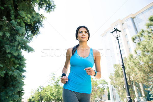 Beautiful woman running outdoors Stock photo © deandrobot
