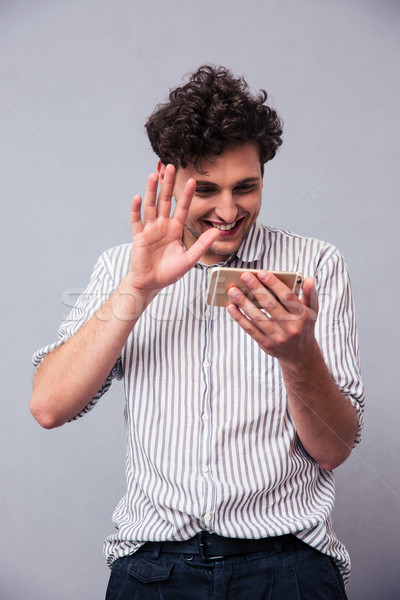 Man showing greeting gesture on web camera Stock photo © deandrobot