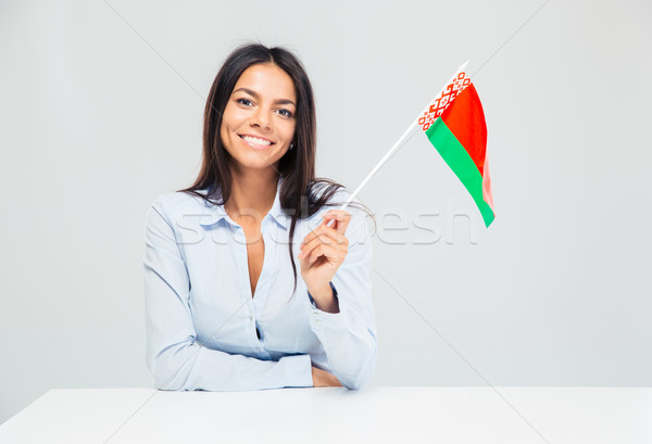 Businesswoman sitting at the table with belarusian flag  Stock photo © deandrobot