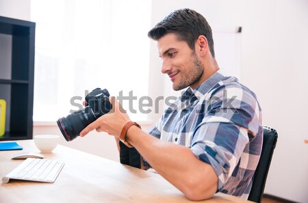 Ohotographer using laptop Stock photo © deandrobot