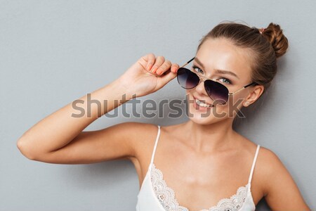 Portrait of a beautiful girl in sunglasses outdoors Stock photo © deandrobot