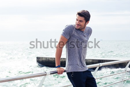 Stock photo: Happy sports man standing near sea