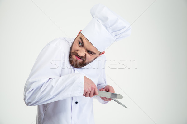 Portrait of a male chef cook sharpening knife i Stock photo © deandrobot