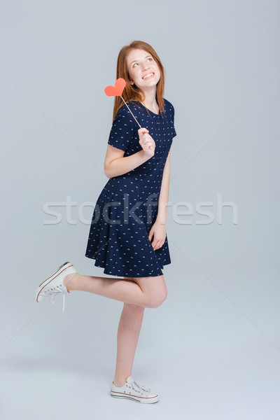 Full length portrait of a happy woman holding red heart Stock photo © deandrobot