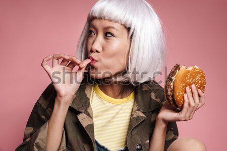 Seductive woman eating pizza and drinking champagne in dressing room Stock photo © deandrobot