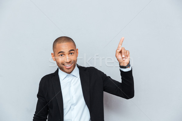Porträt glücklich junger Mann Hinweis Finger up Stock foto © deandrobot